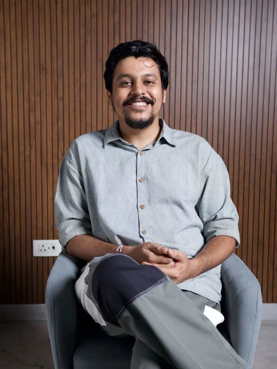 Varun Pandey seated in an armchair, smiling